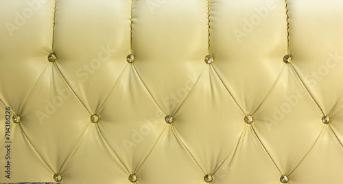 the back of a luxury sofa in retro style with buttons and rhombuses