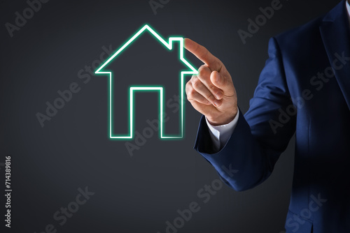 Mortgage rate. Man touching illustration of house on virtual screen against dark background  closeup