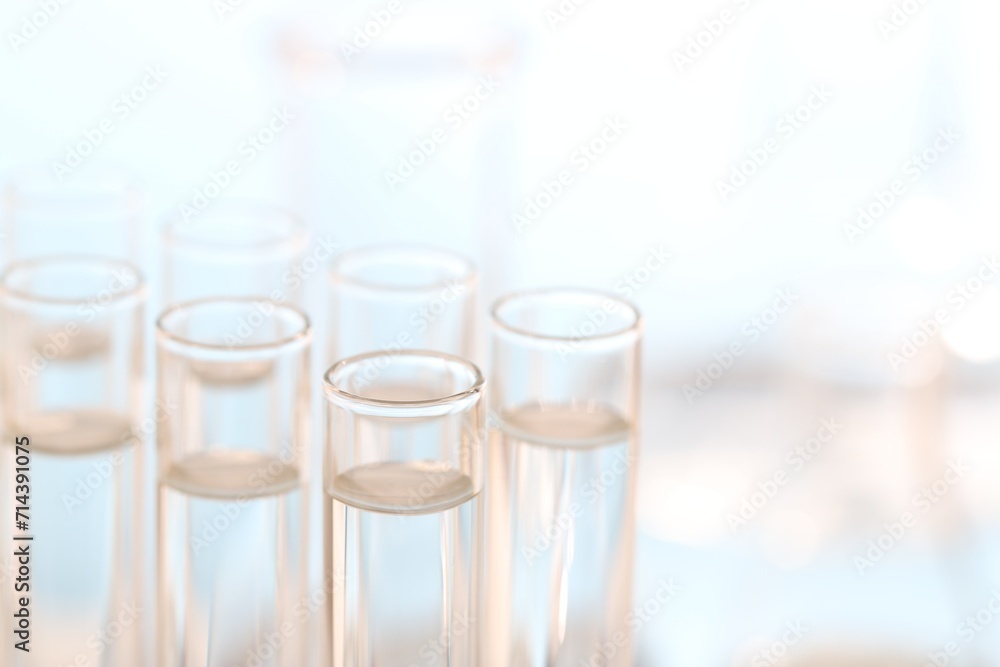 Laboratory analysis. Many glass test tubes on blurred background, closeup and space for text Laboratory analysis. Many glass test tubes on blurred background, closeup and space for text