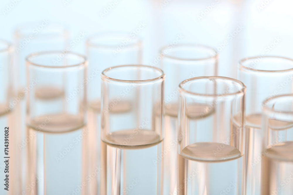 Laboratory analysis. Many glass test tubes on blurred background, closeup Laboratory analysis. Many glass test tubes on blurred background, closeup