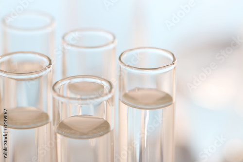 Laboratory analysis. Many glass test tubes on blurred background, closeup