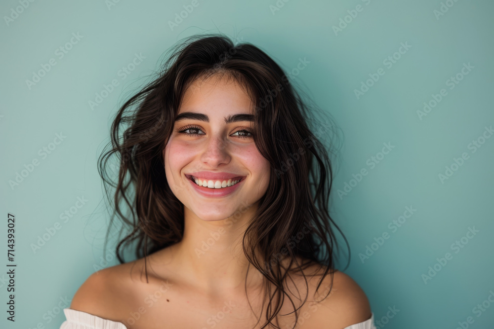 A woman with a smile on her face is wearing a white off the shoulder top A woman with a smile on her face is wearing a white off the shoulder top