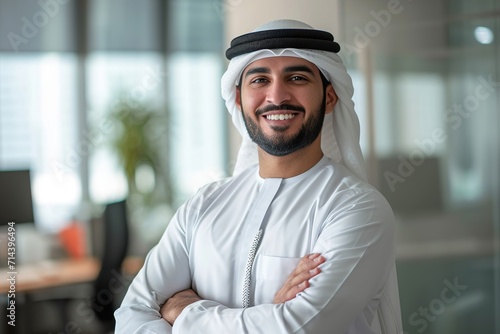 smiling emirati arab at office wearing kandura
