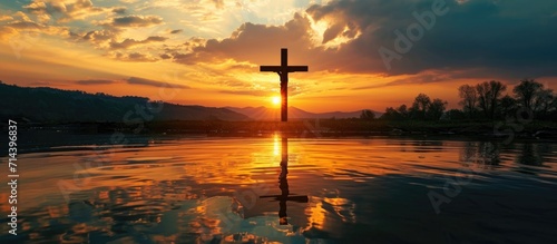 Reflection of Jesus Christ's crucifixion silhouette on Easter Friday in lake