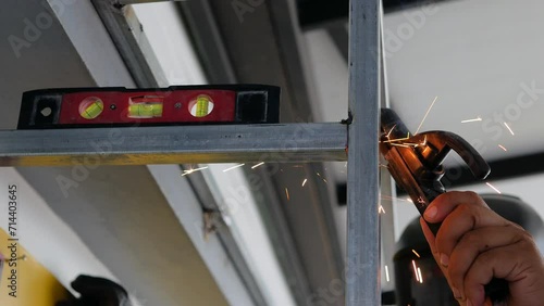 works with metal using a welding machine, bright spark