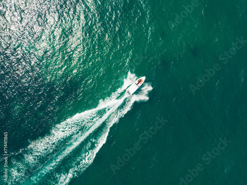 Aerial view of Speed boat at high speed in the aqua sea, Drone view.