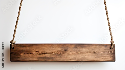 Long blank wood sign  hanging on white background. Low hanging with area for text.  photo