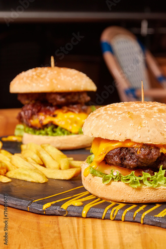 Delicious burger with double meat, caramelized onion, fresh vegetables and potatoes