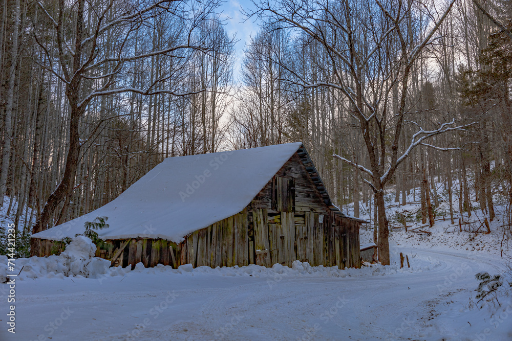 Old barn covered in snow 