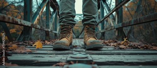 Boot-wearing man on bridge.