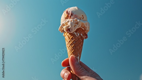 Melting ice cream cone with a backdrop of the sky, capturing the essence of a hot day.