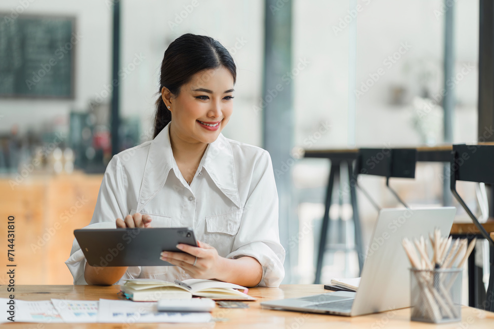 Professional Woman Analyzing Data on Tablet at Desk. Professional Woman Analyzing Data on Tablet at Desk.