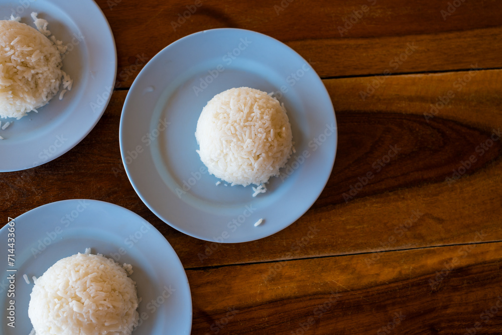Thai Jasmine rice on plate in restaurant. Rice is staple food of Thailand and Asia, providing energy in every meal. Thai Jasmine rice on plate in restaurant. Rice is staple food of Thailand and Asia, providing energy in every meal.