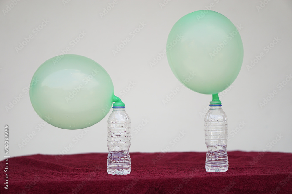 Inflated balloons on top of transparent test bottles. Concept, science