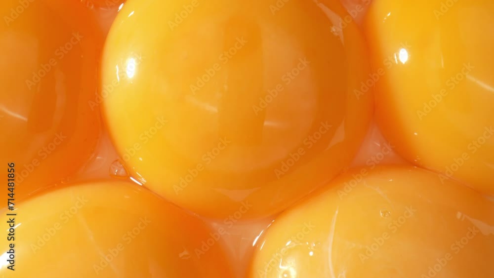 Macro footage examines the scientific marvel of a fresh yolk. Observe the intricate cellular structures, lipid droplets, and protein networks in astounding clarity. Food concept. 4K.