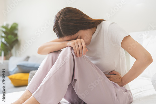 Flatulence ulcer, asian young woman, girl hands in belly, stomach pain from food poisoning, abdominal pain and digestive problem, gastritis or diarrhoea. Abdomen inflammation, menstrual period people. photo