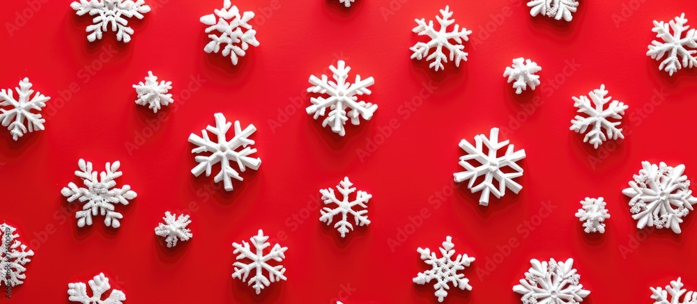Minimal New Year pattern with red background and snowflakes in a flat lay. Minimal New Year pattern with red background and snowflakes in a flat lay.