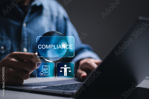 Compliance rules and law regulation policy. Businessman use laptop with compliance icons for enforcement of laws, regulations, and standards. photo