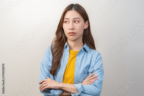 Depressed, distracted asian young woman in casual tired stressed with problem, portrait of brunette with long hair, feeling sad lonely, standing alone avoid looking, isolated on white background. photo