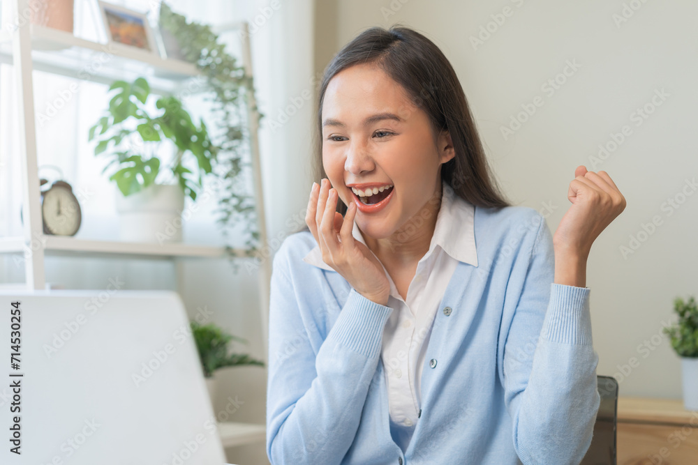 Excited with computer, happy celebrating success asian young woman, girl amazed looking good news at pc, laptop on desk at home office, get win online lottery, student winner celebrating achievement. Excited with computer, happy celebrating success asian young woman, girl amazed looking good news at pc, laptop on desk at home office, get win online lottery, student winner celebrating achievement.