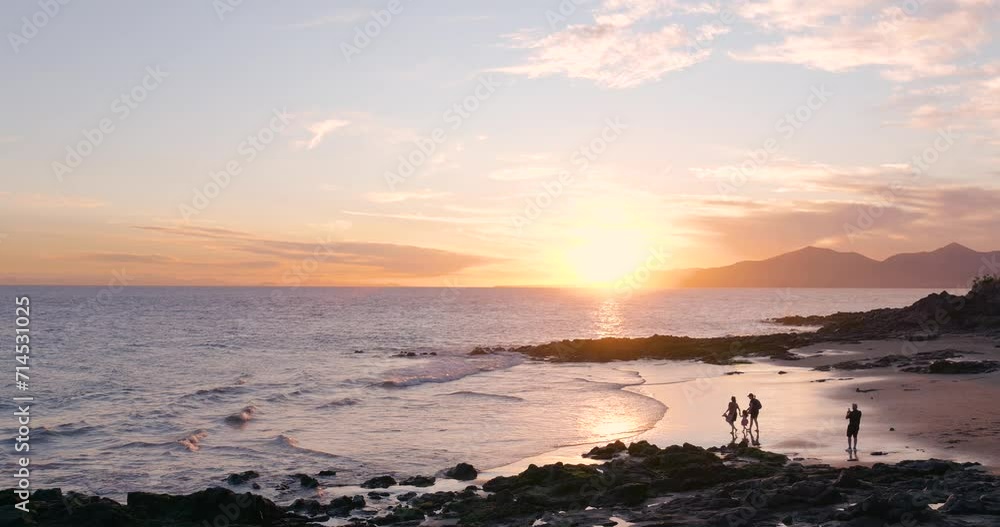 Family at the beach during sunset taking pictures Family at the beach during sunset taking pictures