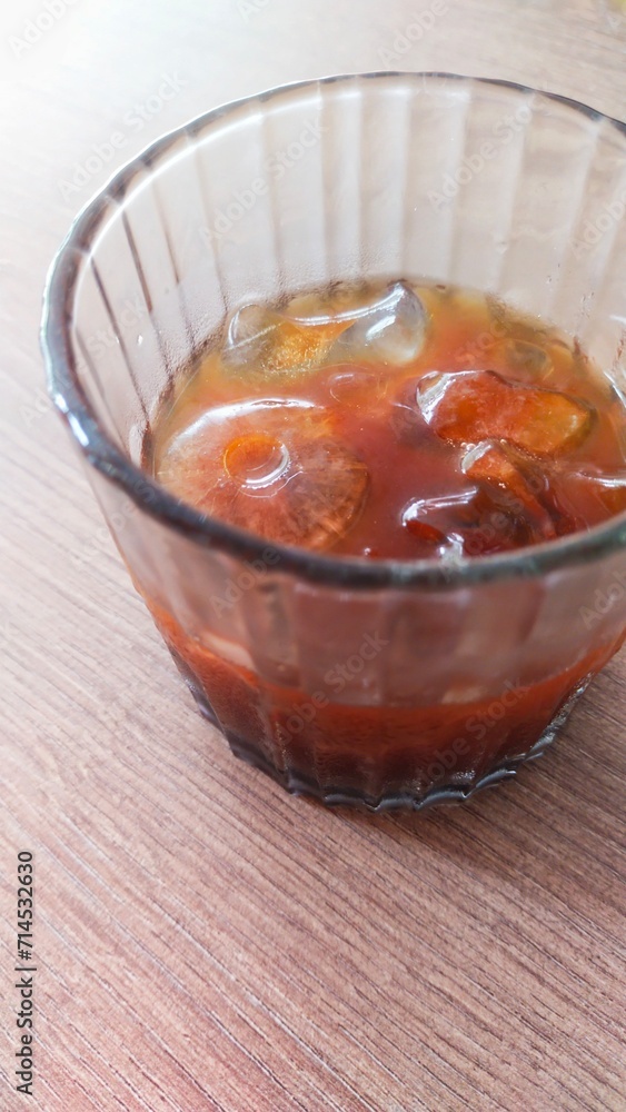 a glass of cold and refreshing iced black coffee on the table