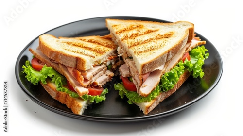 Club sandwich on a black plate isolated on white background