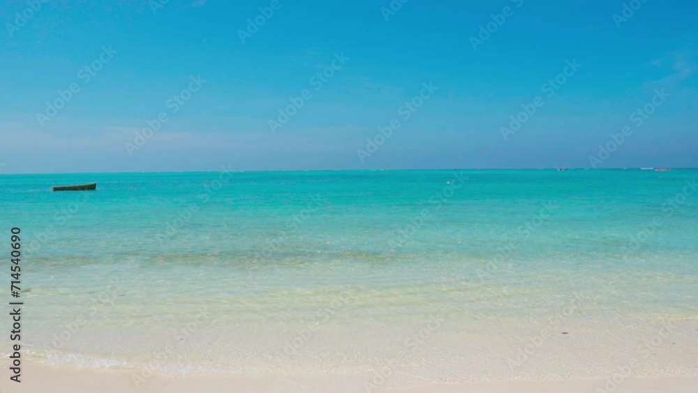 Beautiful view of turquoise color water of tropical beach at Lakshadweep Island, India. Summer vacation beach background. Tranquil beach waves and blue sky during summertime. Beautiful view of turquoise color water of tropical beach at Lakshadweep Island, India. Summer vacation beach background. Tranquil beach waves and blue sky during summertime.