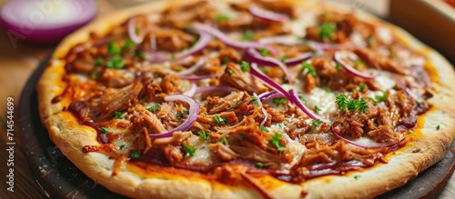 Tasty homemade pizza with BBQ pulled pork and red onion. photo