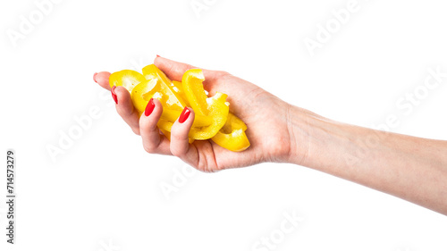 Yellow sweet bell pepper slices in hand isolated on a white background. Woman holding bulgarian pepper. Healthy food and ingredients concept