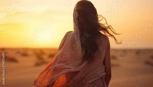 Beautiful woman in the desert at sunset, ramadan concept