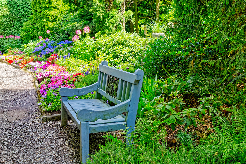 Park bench with colorful flowers in the background Park bench with colorful flowers in the background