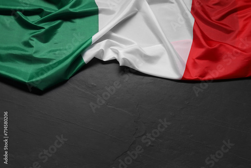 Flag of Italy on black background, top view. Space for text