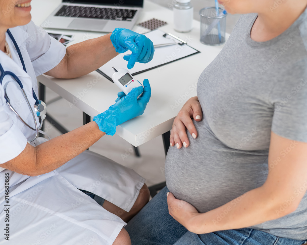The doctor checks the blood sugar level of a pregnant patient. Gestational diabetes. The doctor checks the blood sugar level of a pregnant patient. Gestational diabetes.