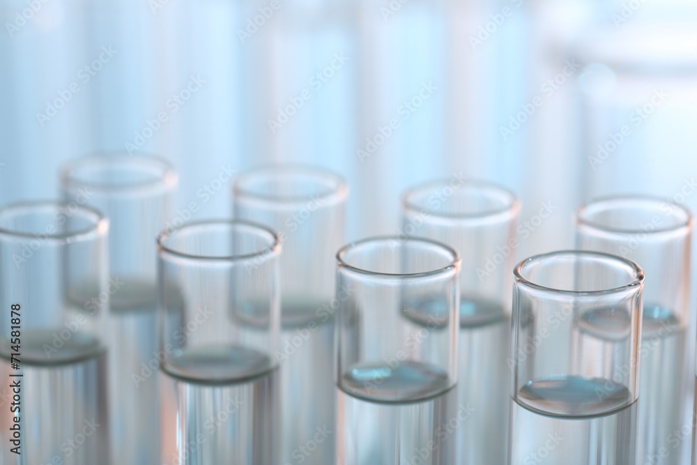 Laboratory analysis. Many glass test tubes on blurred background, closeup Laboratory analysis. Many glass test tubes on blurred background, closeup