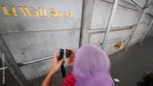 Boy and girl shoot text 14 Wall Street in new York at summer photo