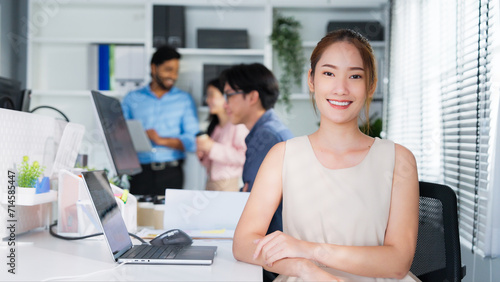 Portrait of attractive young Asian businesswoman smiling in office on desk workspace. Beautiful woman confident. Emotions happy. business worker