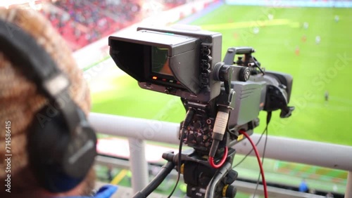Cameraman shoots video reportage at stadium during game  photo