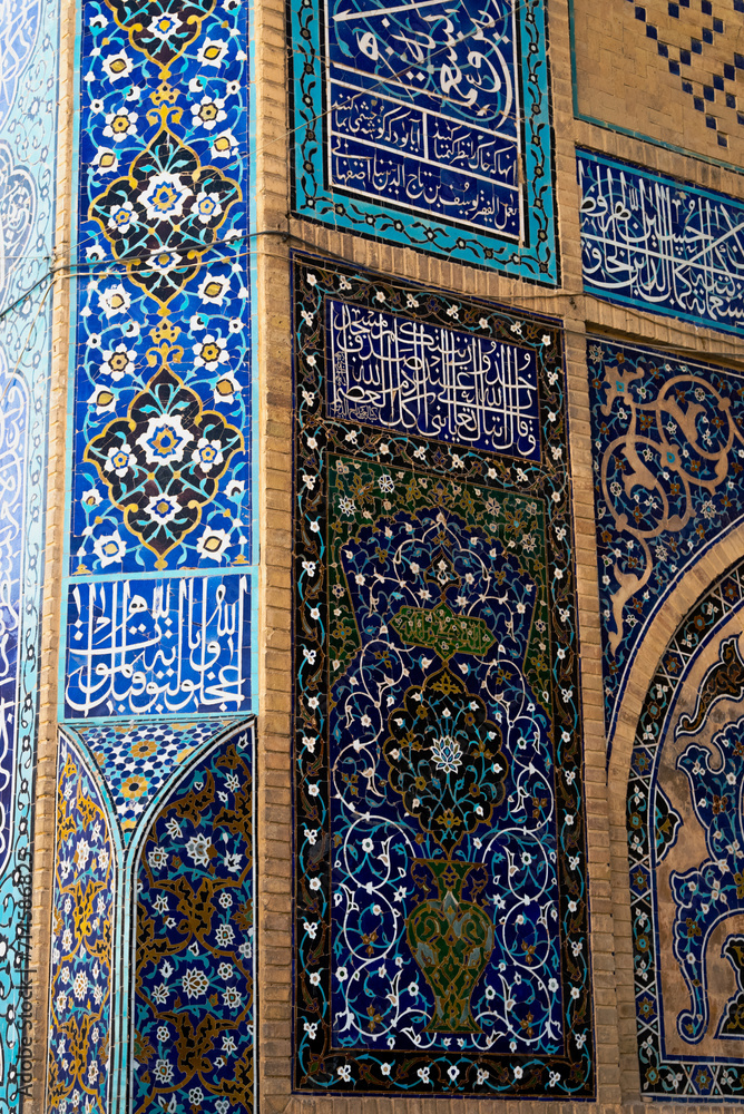 Detail of traditional Persian mosaic wall with floral ornament. West iwan of the courtyard of Jameh or Jame Mosque , Iran's oldest mosque in Isfahan, Iran. UNESCO World Heritage.