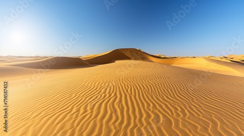  the sun shines brightly in the distance over the sand dunes of a desert in the middle of the desert, with a clear blue sky in the foreground.