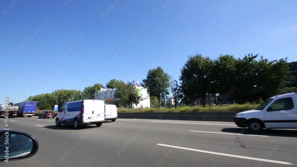 Several cars move fast along the highway in the suburbs of Paris. Several cars move fast along the highway in the suburbs of Paris.