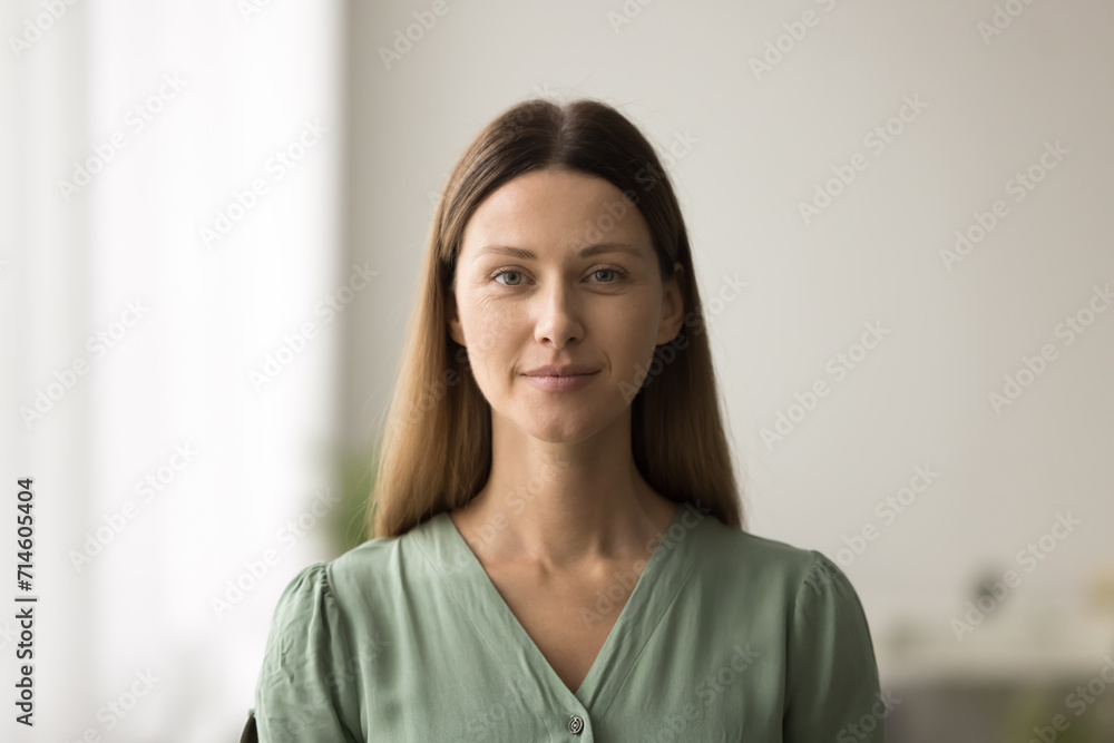 Happy beautiful 30s Caucasian woman posing indoors, looking at camera with friendly smile. Pretty female beauty care model, businesswoman in casual video call head shot portrait Happy beautiful 30s Caucasian woman posing indoors, looking at camera with friendly smile. Pretty female beauty care model, businesswoman in casual video call head shot portrait