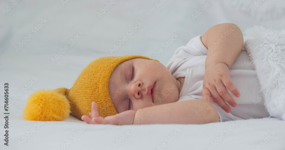 a baby in a white bodysuit is sleeping on a white background, hugging a bear. child. a baby in a white bodysuit is sleeping on a white background, hugging a bear. child.