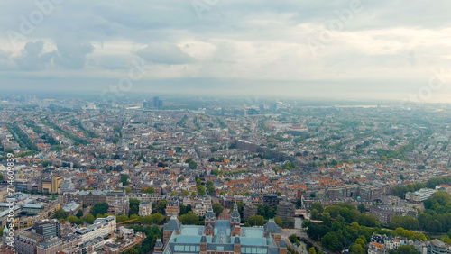 Amsterdam, Netherlands. Historical city center with canals. Panoramic view of the city in summer in cloudy weather, Aerial View