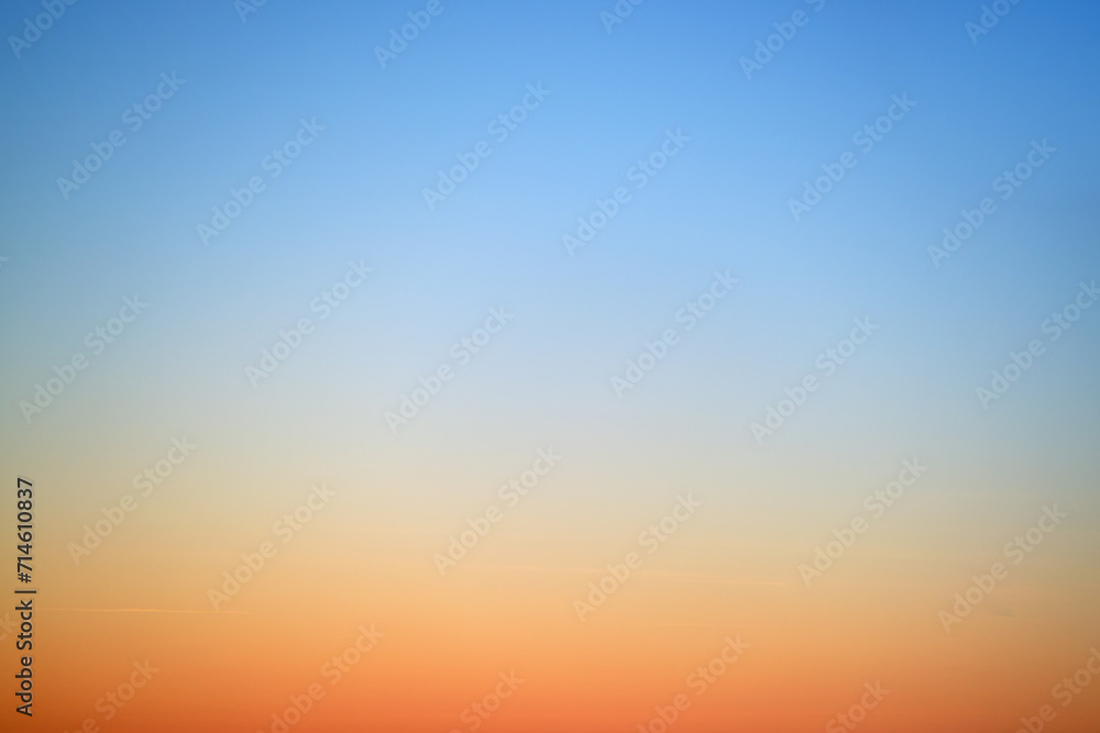The gradient of the sunset sky from red-orange to blue