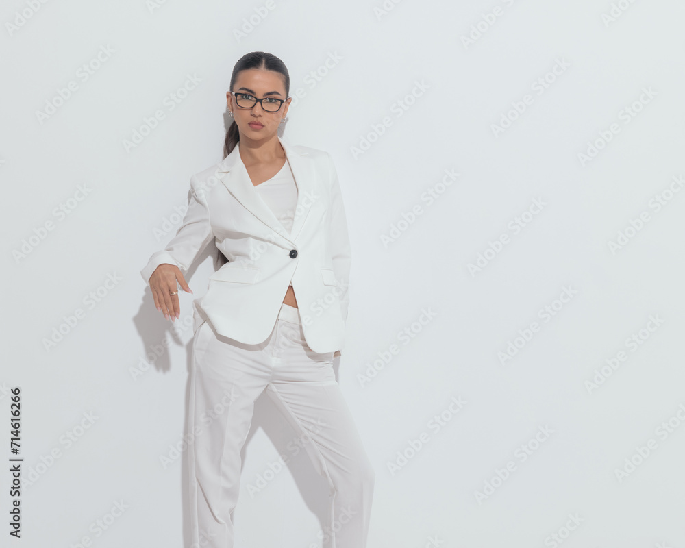 cool elegant girl with glasses holding hands in pockets and posing cool elegant girl with glasses holding hands in pockets and posing
