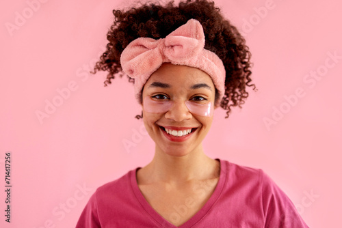Smiling attractive mixed race girl with clean skin and pink patches under her eyes.