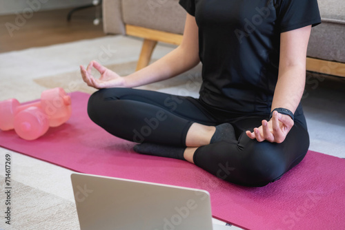 Healthy young woman doing breathing exercises at home, beautiful woman meditating at home with eyes closed, practicing yoga, doing pranayama techniques Mindfulness meditation concept