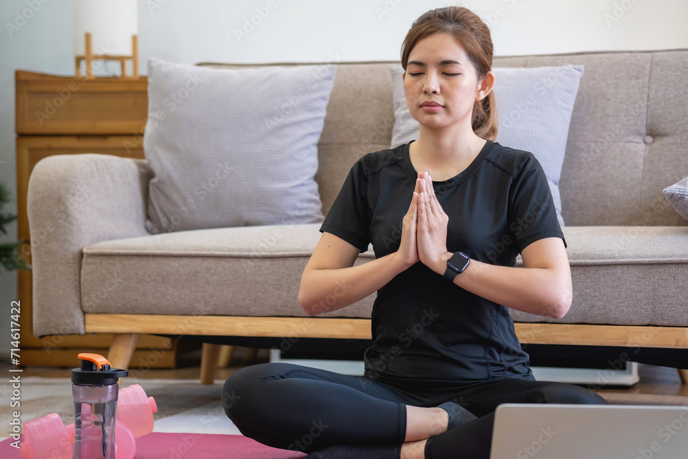 Healthy young woman doing breathing exercises at home, beautiful woman meditating at home with eyes closed, practicing yoga, doing pranayama techniques Mindfulness meditation concept Healthy young woman doing breathing exercises at home, beautiful woman meditating at home with eyes closed, practicing yoga, doing pranayama techniques Mindfulness meditation concept