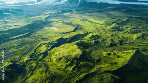  an aerial view of a mountain range with a river running between it and a mountain range with a river running between it and a mountain range in the far distance.
